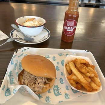 Rodney Scott's BBQ signature dishes Carolina Style Pork Sandwich, Beef Brisket, Bag of Skins.